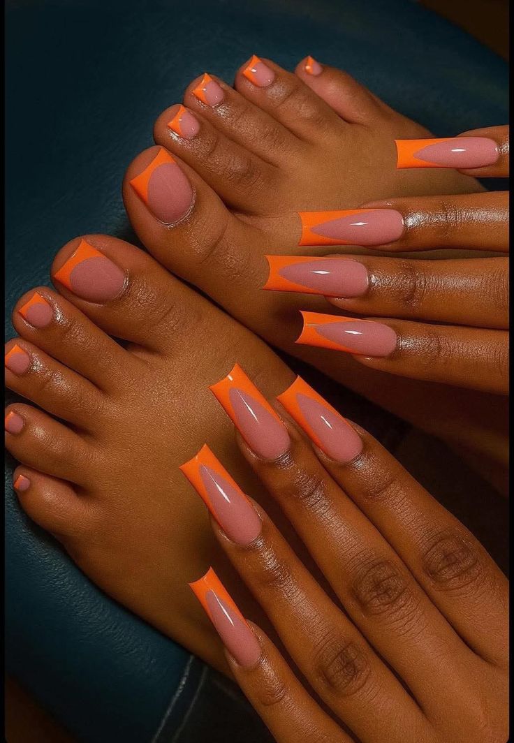 Bright orange French tip manicure and pedicure set with a polished salon finish